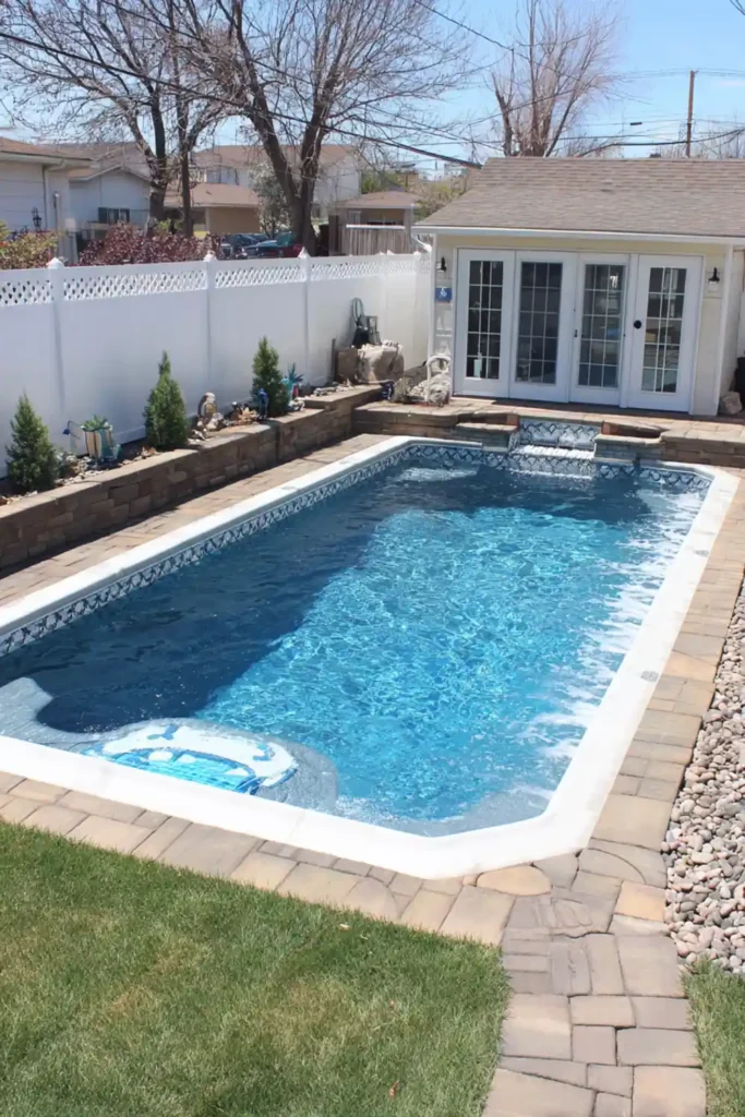 Rectangular semi in-ground pool with Kontiki patterned liner and stone path