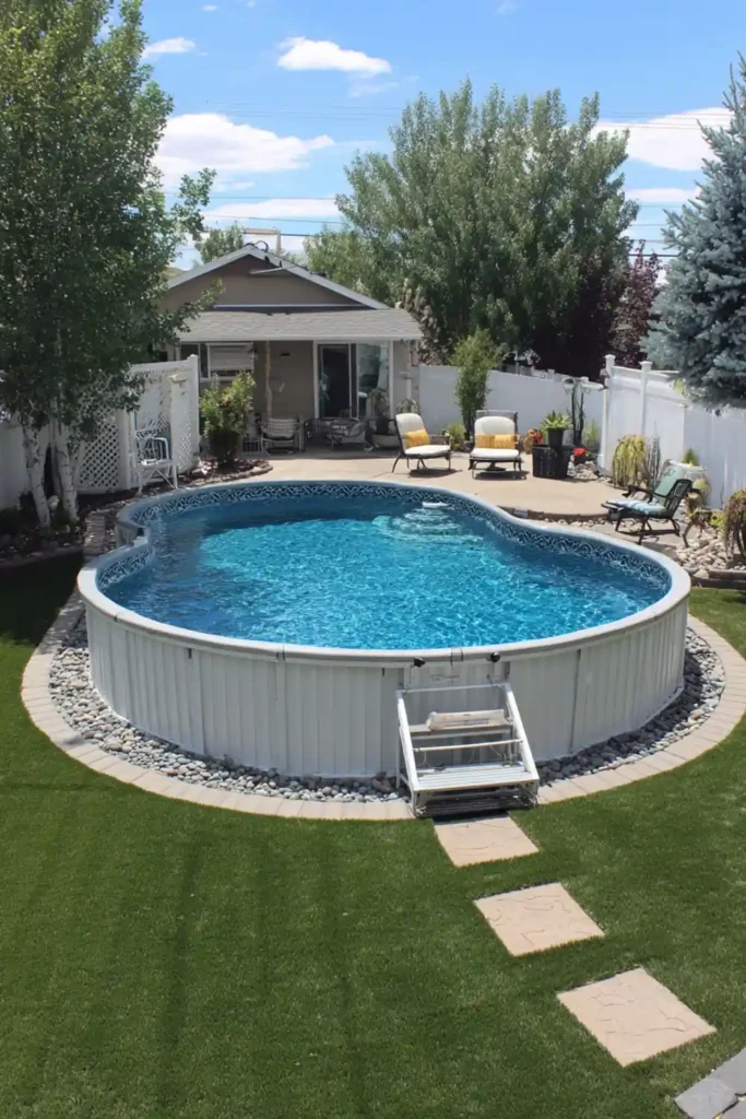 Round above-ground pool with soft blue water and simple seating area in backyard