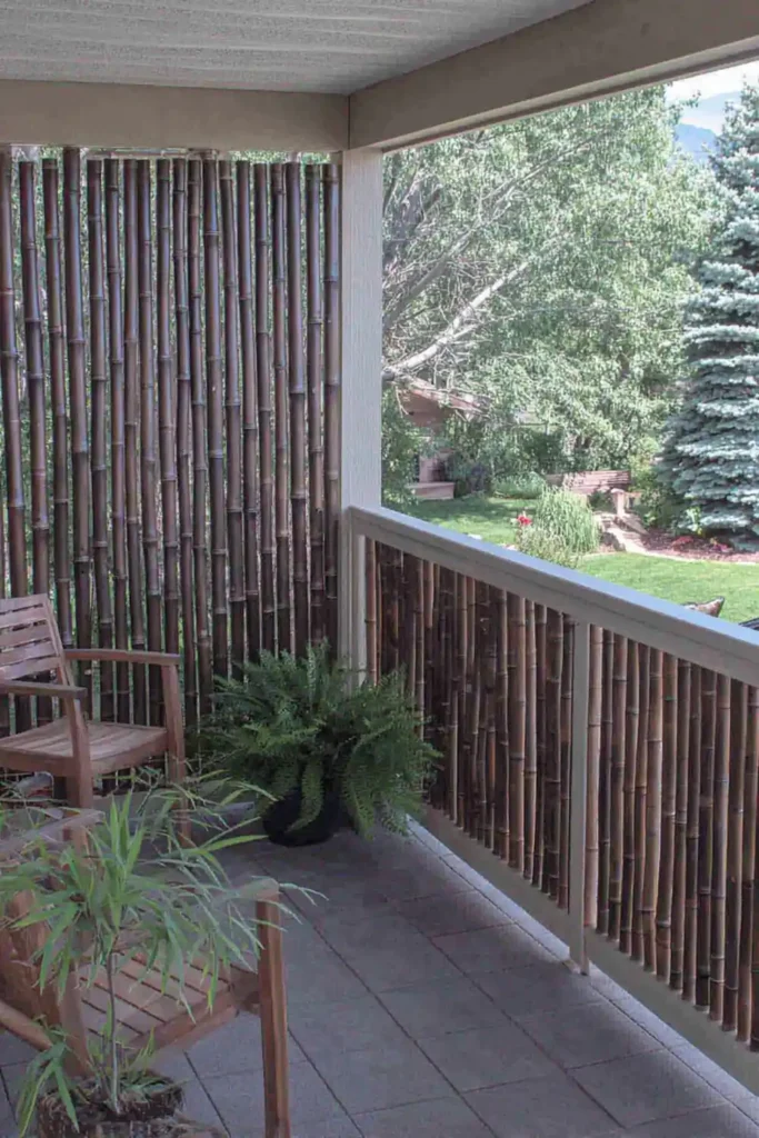 33 Privacy Fence Ideas That Make Your Yard Feel More Peaceful 25 Bamboo privacy fencing surrounding a small patio seating area