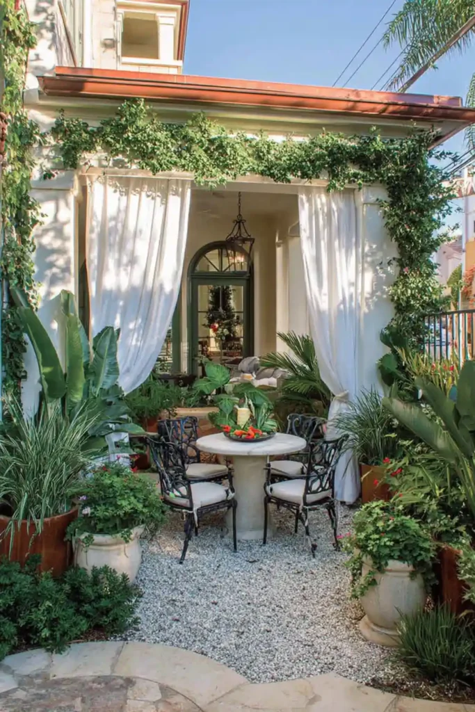 cozy courtyard garden with outdoor dining table and potted plants