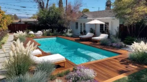 Above-ground pool with wooden deck, lounge chairs, and soft landscaping in a relaxed backyard setting