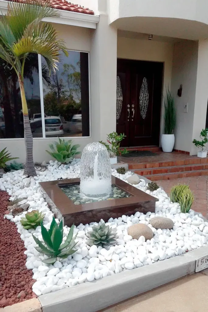 Modern front garden with pebble ground cover and a small fountain feature