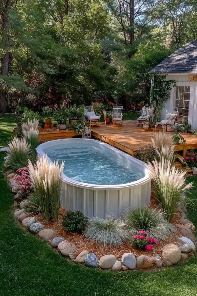Mulched garden bed with shrubs and tall grasses around an above-ground pool