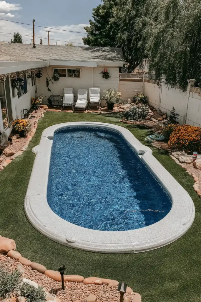 Oval semi in-ground pool placed in a narrow backyard with small seating area