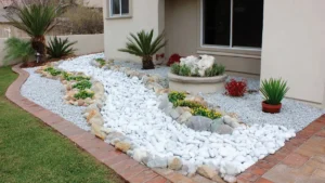 Backyard with curved pebble dry creek, flower bed, and simple pebble walkway in a clean residential garden