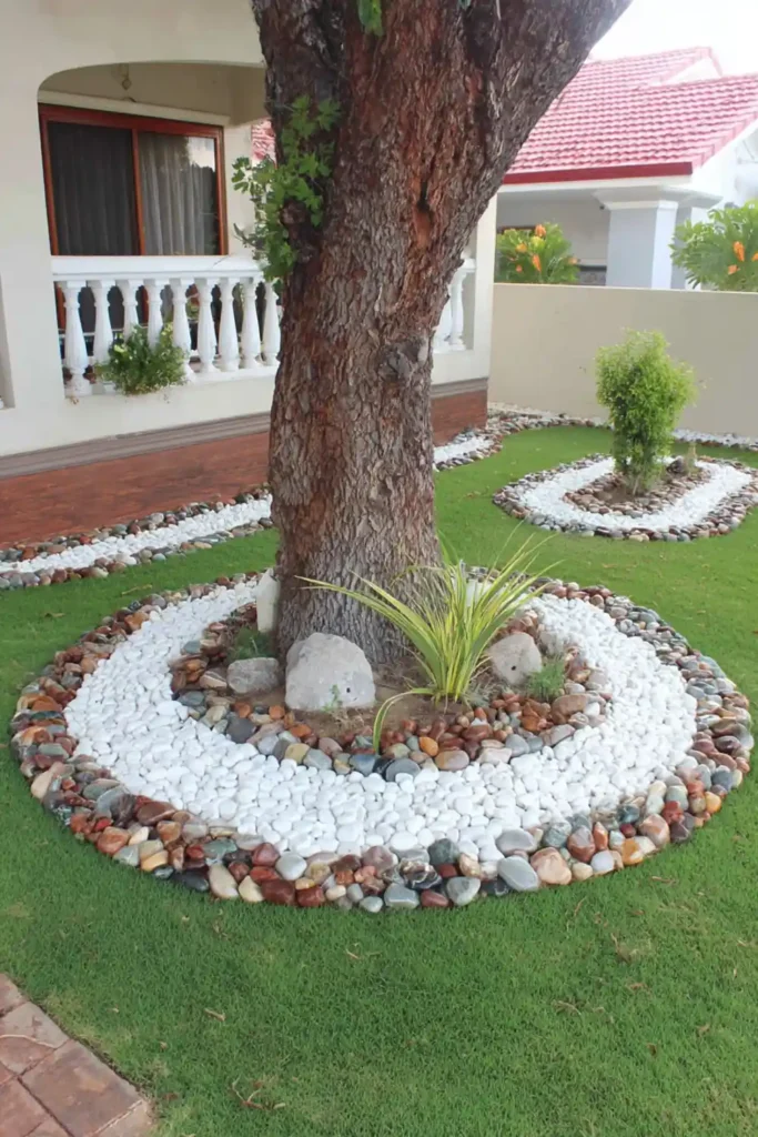 Tree surrounded by a circular pebble bed with ornamental grasses in a clean backyard
