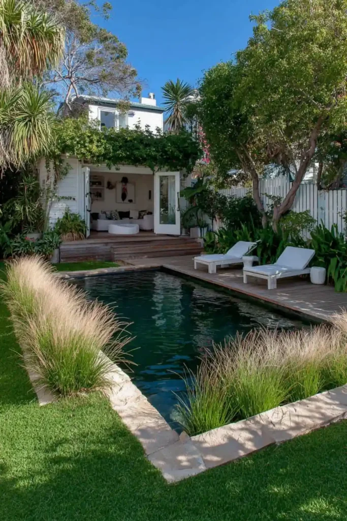 Above-ground pool surrounded by ornamental grasses creating a soft natural border