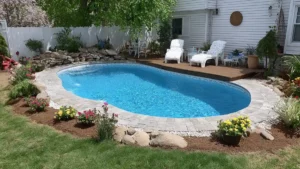 semi in-ground pool design ideas with simple wooden deck and lawn in a relaxed residential yard