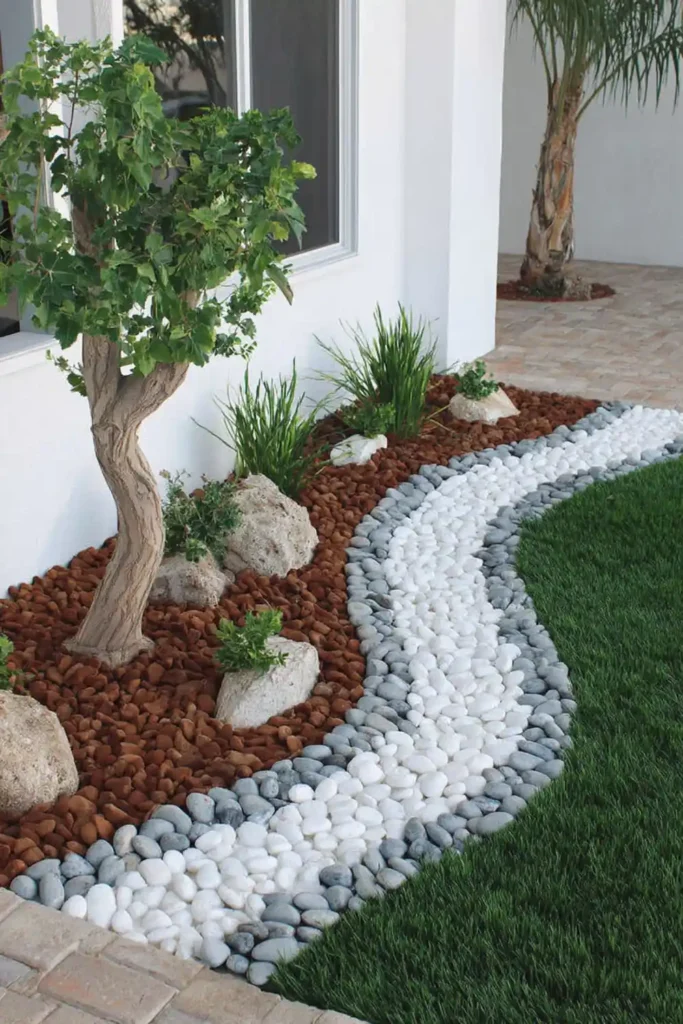 Two-tone pebble stream design with light and dark stones forming a contrast pattern
