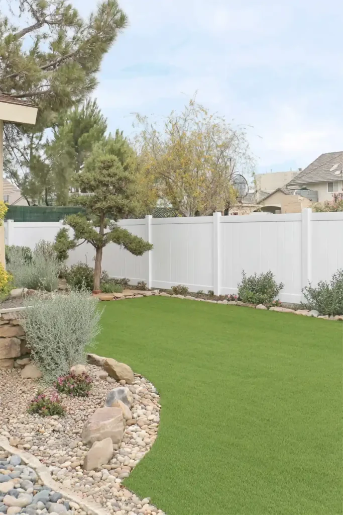 33 Privacy Fence Ideas That Make Your Yard Feel More Peaceful 27 White vinyl privacy fence panels surrounding a backyard lawn