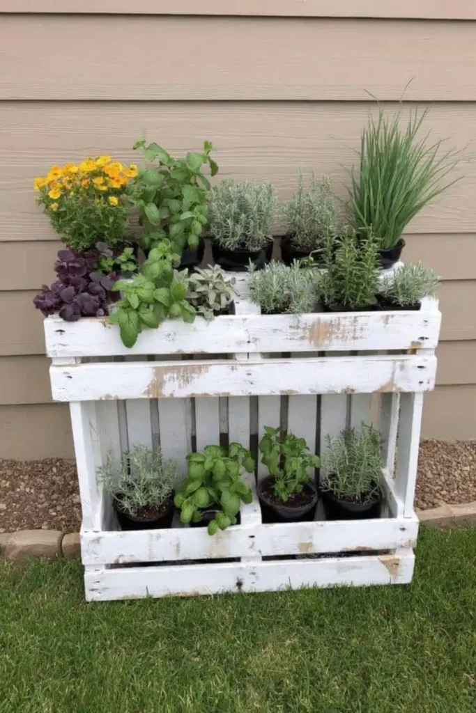 Whitewashed farmhouse pallet garden with small plants against pale siding