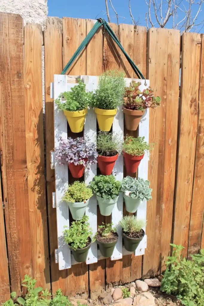 Moveable pale mint pallet wall garden with hanger loops and terracotta pots