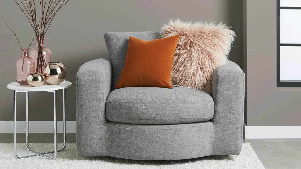 Trend Color Spotlight: Off the Grid Paint Inspiration for Warm, Modern Rooms 6 Warm modern room vignette with beige-gray Off the Grid walls, gray seating, orange accents, blush texture, and metallic decor.
