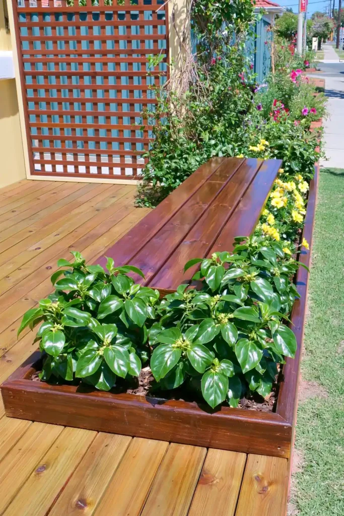 20 Budget-Friendly Outdoor Landscaping Ideas for a Charming Yard 16 Wooden garden bench beside a built-in planter box filled with greenery.