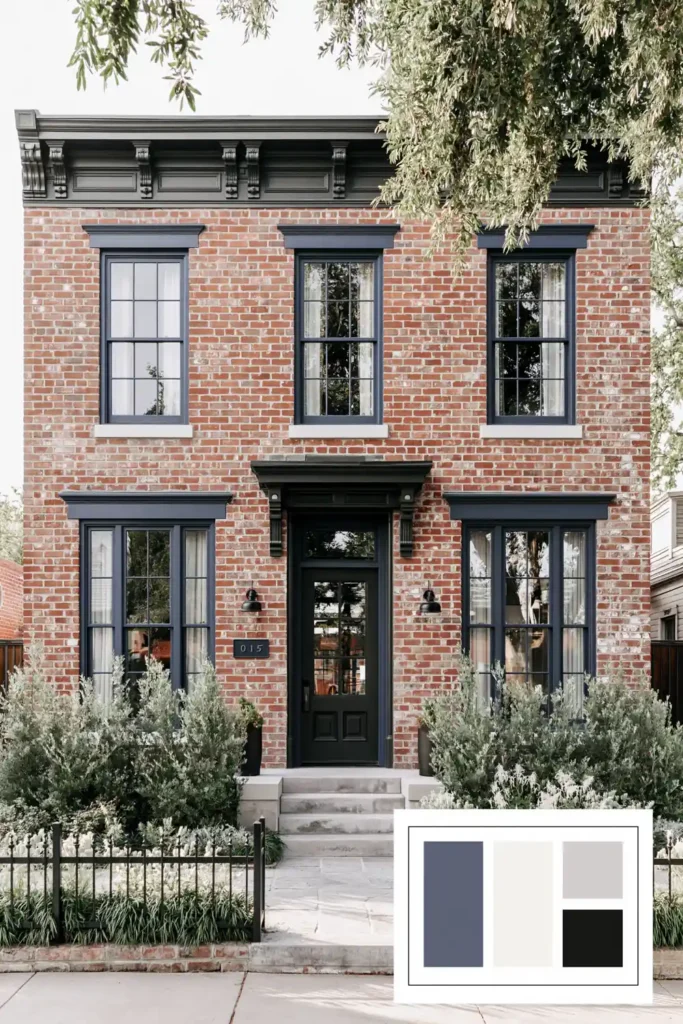 Classic Exterior Paint Color Combinations for a Timeless Home Look 9 Red brick exterior with blue-teal trim, dark front door, black accents, green shrubs, stone steps, and a low black fence.