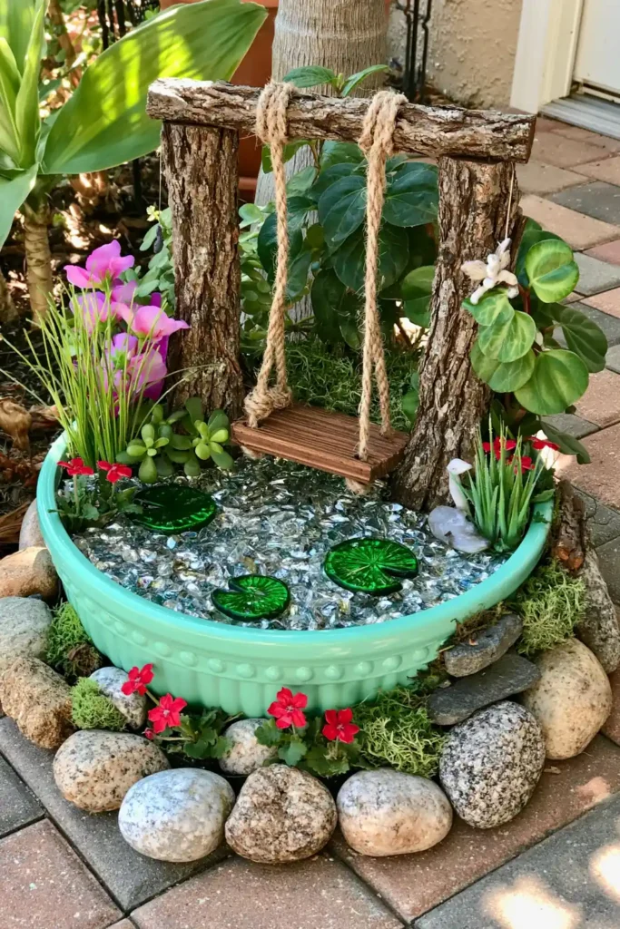 DIY Outdoor Fairy Garden Ideas for Tiny Backyard, Patio, and Seasonal Displays 9 Spring fairy garden with a turquoise container pond, blue glass water, rope swing, green plants, lily-pad shapes, red flowers, and stones.