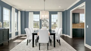 Formal dining room with deep blue walls and white trim for a cohesive whole house paint palette