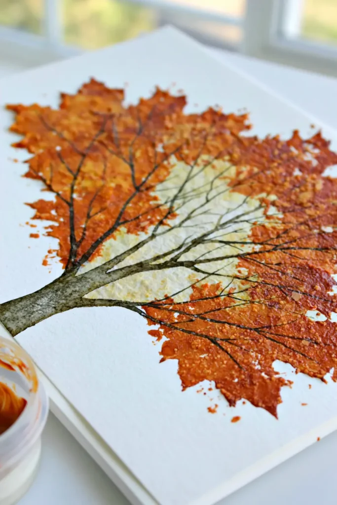 Fall tree watercolor painting with orange and yellow foliage on white paper for seasonal wall decor.