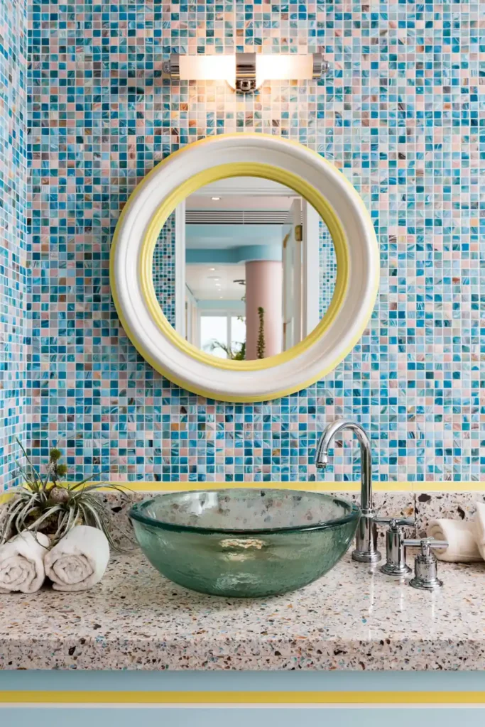 Bathroom Color Schemes That Never Go Out of Style 6 Blue and yellow bathroom color scheme with mosaic tile wall, yellow-framed mirror, glass vessel sink, and chrome faucet