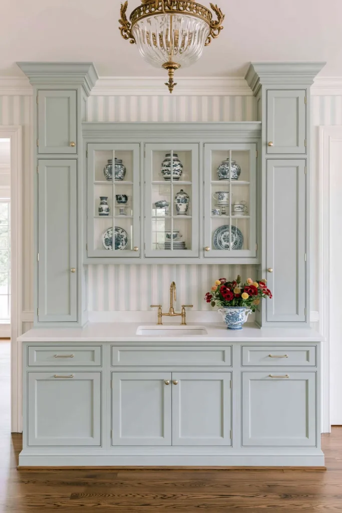 Timeless vs. Trendy Home Decor: 20 Ideas for a Well-Proportioned, Beautiful Home 6 Powder-blue built-in cabinets with matching trim, striped wallpaper, glass-front doors, blue-and-white ceramics, and a gold chandelier.