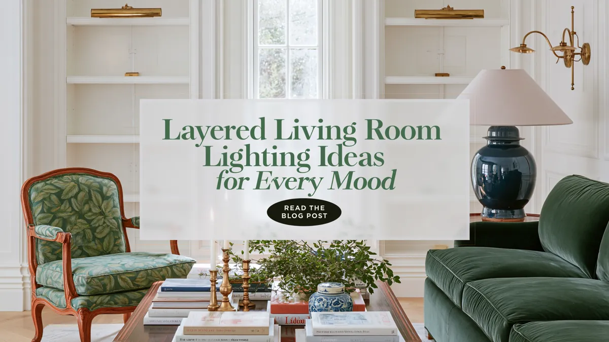 Layered Living Room Lighting Ideas for Every Mood 1 Traditional living room with a deep green velvet sofa, layered brass wall lighting, a blue ceramic table lamp, built-in bookcases, and a styled dark wood coffee table.