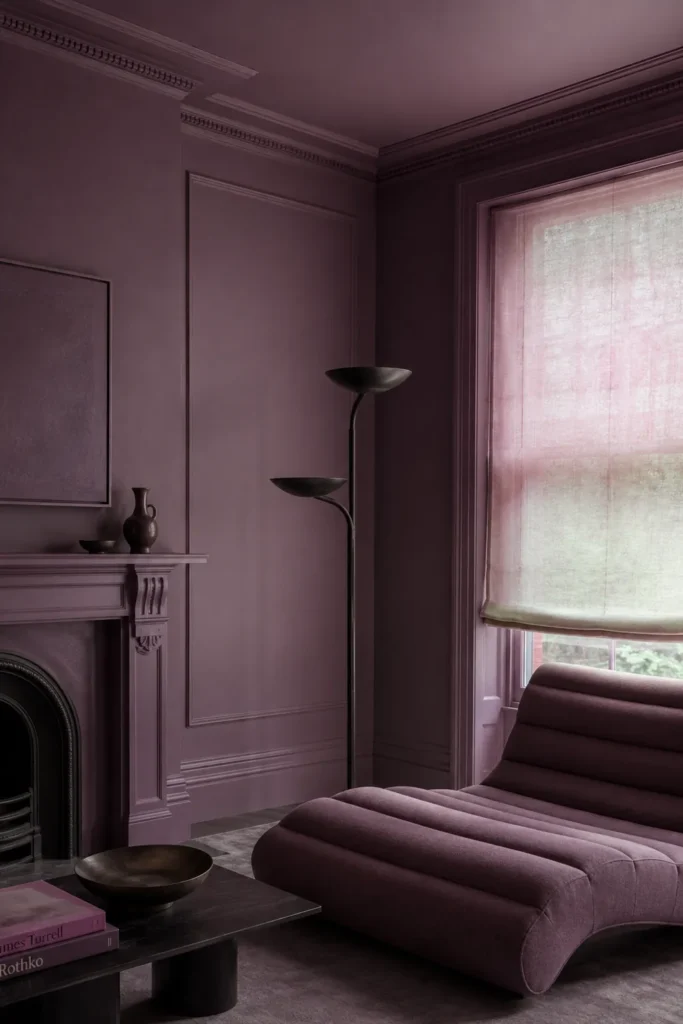 20 Best Living Room Color Combinations for a Warm Feel 15 Moody lilac living room with mauve walls and ceiling, a sculptural chaise, translucent window shade, and black floor lamp.