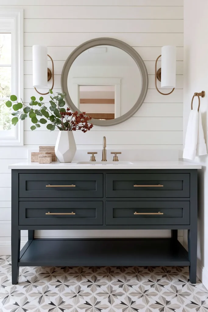 21 Guest Bathroom Decorating Ideas for a Friendly Space 7 Modern guest bathroom with a blue-green vanity, brass details, white paneled walls, and patterned geometric floor tiles.