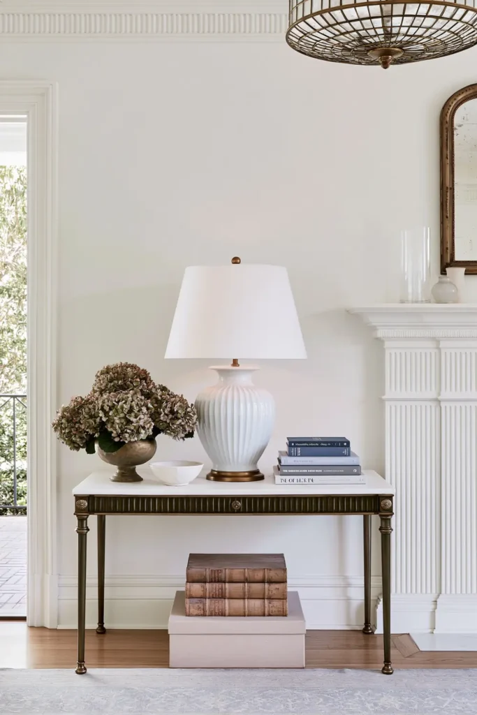 Timeless vs. Trendy Home Decor: 20 Ideas for a Well-Proportioned, Beautiful Home 12 Sculptural accent table lamp on a simple console in a bright neutral room with soft traditional styling.