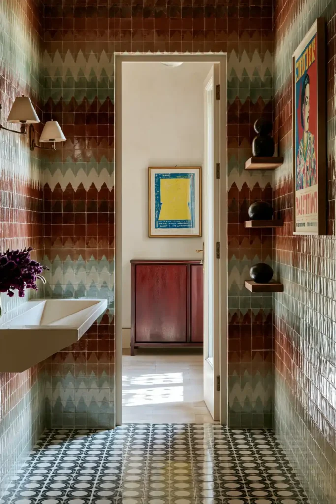 20 Bathroom Shelf Styling Ideas for Beautiful, Practical Storage 9 Bold patterned bathroom with three thick wooden shelves, colorful framed art, purple flowers, and black-and-white circular floor tiles.