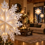 Large white paper snowflakes glowing in a warm holiday living room beside a decorated Christmas tree.