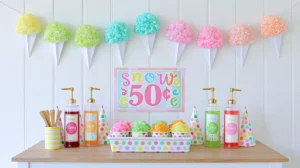 Colorful DIY snow cone garland decor with pastel glitter snow cones hanging above a summer party station featuring syrup bottles, polka-dot cups, and wooden spoons.