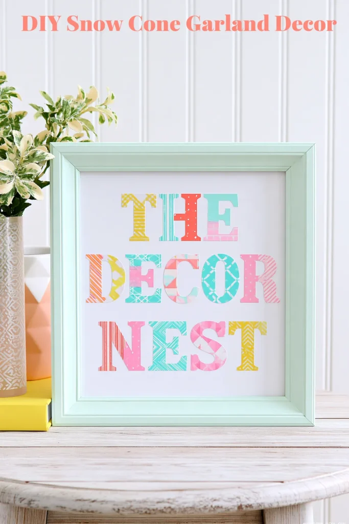 Mint-green picture frame displaying colorful Summer Love washi tape artwork with pastel geometric lettering, a decorative vase, and a bronze-gold ornament.